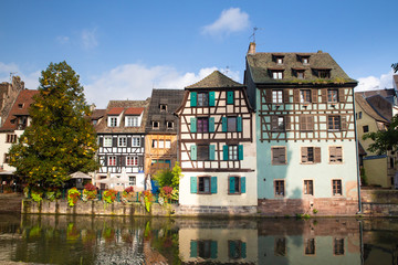 Fototapeta na wymiar View of beautiful half-timbered houses along the canal seen from Strasbourg France