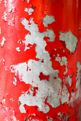 Close up Peeling old red paint over grey background, great texture