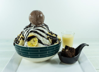 Bing su chocolate banana in a dish on white background, Korean dessert, Front view.