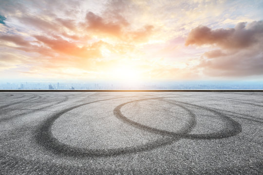 Panoramic skyline and buildings with empty race track road - Powered by Adobe