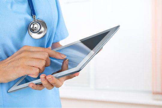 Doctor using digital tablet.