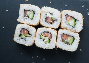 Japanese rolls on black background.