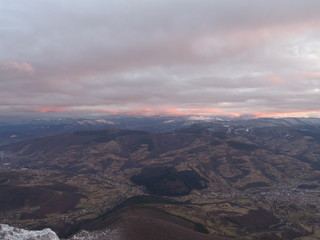 aerial view of fresh snow covered winter forest in high mountains in sunset on christmas eve
