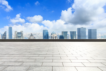 Panoramic Shanghai skyline and buildings with empty concrete square floor