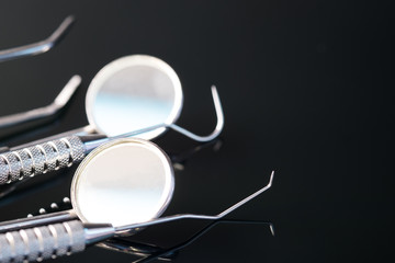 Dental tools use for dentist in the office or clinic. On the black background.