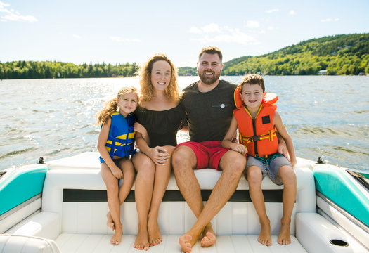 Family out boating together having fun on vacancy