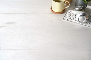 Office white wooden with office supplies and copy space.
