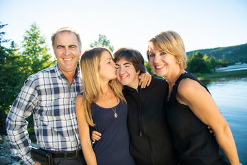Couple outdoors with childs by lake having good time