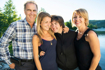 Couple outdoors with childs by lake having good time