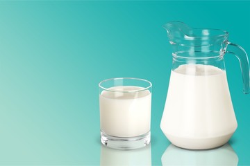 Glass of milk and jug on  white