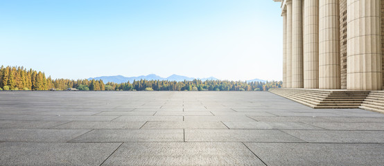 Empty square floor and modern architecture with mountain natural scenery