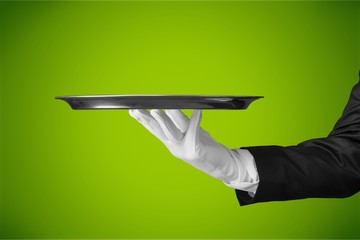 Elegant waiter hand in white glove holding
