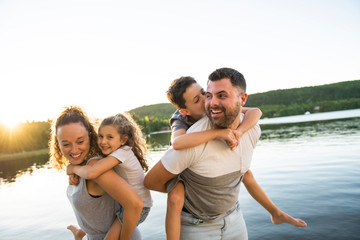 Family on the pier warm summer day having good time