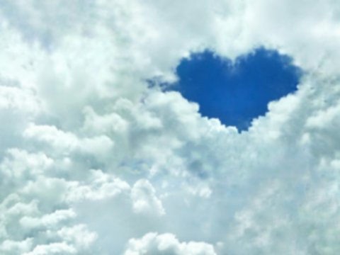 Blur image of blue heart shaped in many white clouds with blue sky for natural background design and love concept