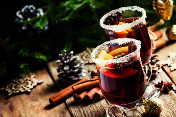 Christmas and New Year festive drink, hot mulled wine with cinnamon, cardamom, orange and anise...