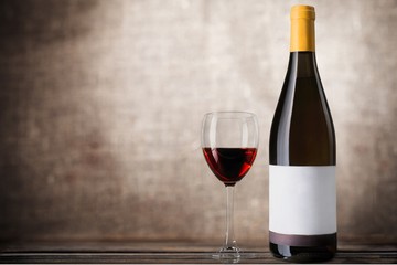 Red wine glass on wooden desk at