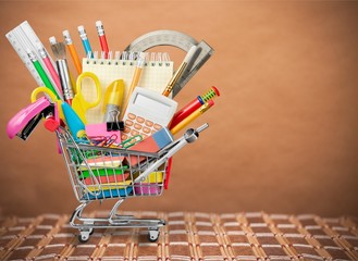 Variety office supplies in little shopping cart