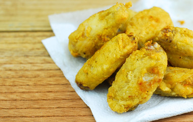 Crispy fried chicken on wooden background