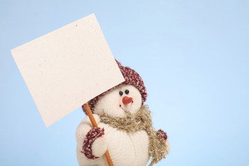 Snowman holding a blank sign