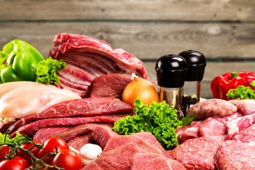 Fresh raw meat with vegetables on brown