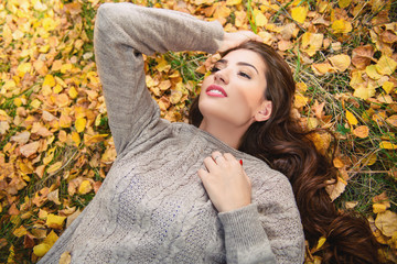 lying on golden leaves