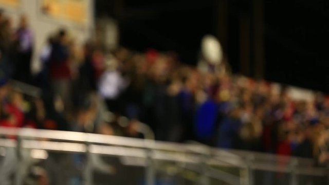 DEFOCUSED CROWD AT FOOTBALL GAME IN STANDS