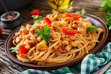 Spaghetti bolognese pasta with tomato sauce, vegetables and minced meat - homemade healthy italian pasta on rustic wooden background.