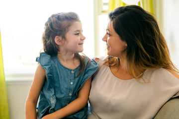 mother and daughter Having great time on the sofa