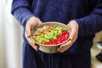 Fitness and healthy lifestyle concept. Female eating a healthy oatmeal after a workout.
