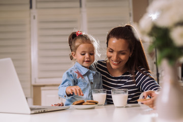 mother and daughter having dinner at home