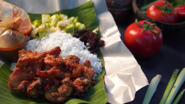 nasi kukus, traditional malay steamed rice with tumeric fried chickens