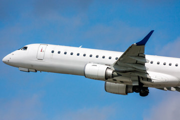 Close-up white passenger airplane in the air on take-off