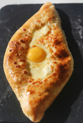 Tasty bright macro photo of Adzhar-style khachapuri