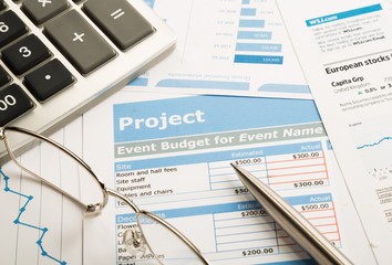Glasses, Pen And Calculator On Financial Reports Close-up
