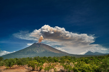 29 June 2018, Bali, Indonesia.Mount Agung volcano dramatic eruption over dark blue sky . Massive...