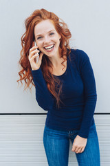 Cheerful young woman talking on mobile phone