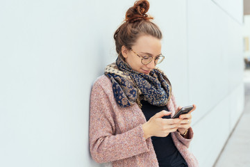 young woman using her mobile outdoors