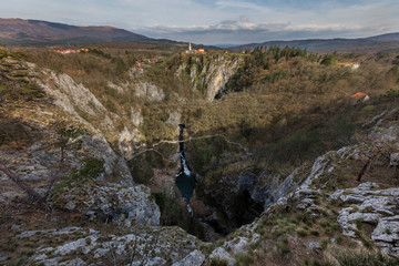 Panoramic view of Skocjanske jame with village Skocjan and collapse doline with cave entrances, Slovenia