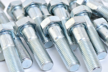 Fasteners on a white background. Manufacture of metal products.