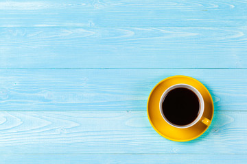 Obraz na płótnie Canvas Bright colored coffee cup on a table top view