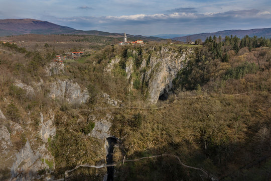 Unesco world heritage site Skocjanske jame with village Skocjan and collapse doline with cave entrances and paths, Slovenia
