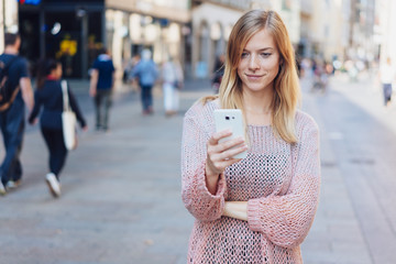 Young woman standing in a city street