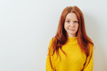 Puzzled young woman pulling a whimsical expression