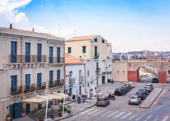 Fototapeta na wymiar View of old street, facades of ancient buildings in Ortygia (Ortigia) Island, Syracuse, Sicily, Italy