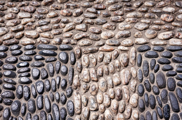 Sidewalk paved with sea stones in park (Parco Bellini) in Catania, Sicily, Italy