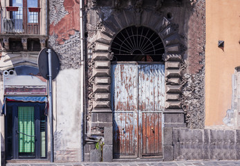Fototapeta na wymiar View on street of Catania, Sicily, Italy - facade of an ancient building