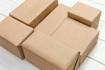 Brown mail package parcel blank for you design. Cardboard box on a wooden background