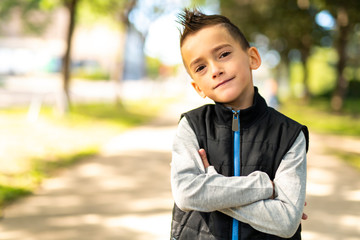 A nice boy outside posing as a model