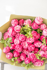 Beautiful spring bouquet. Arrangement with mix flowers. The concept of a flower shop. Pink color. Work florist.