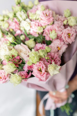 beautiful spring bouquet. Young girl holding a flowers arrangement with lisianthus of pink colors